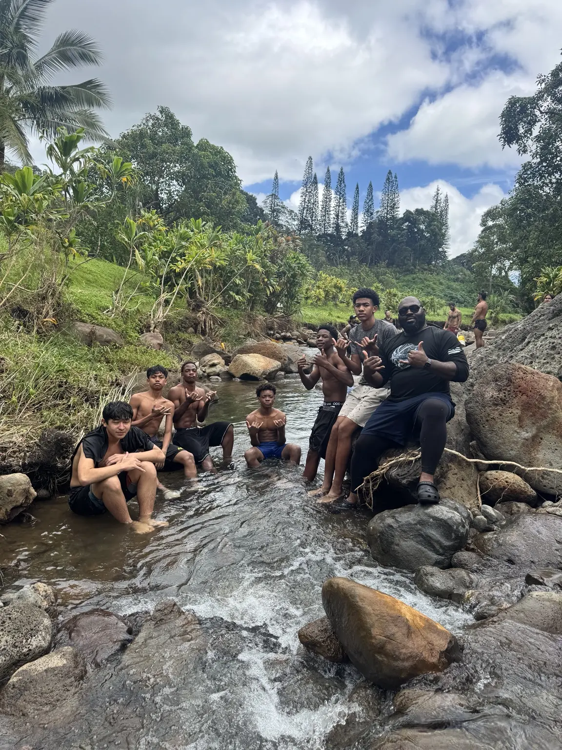 Moanalua Boys Basketball team gathered together during an outdoor service project