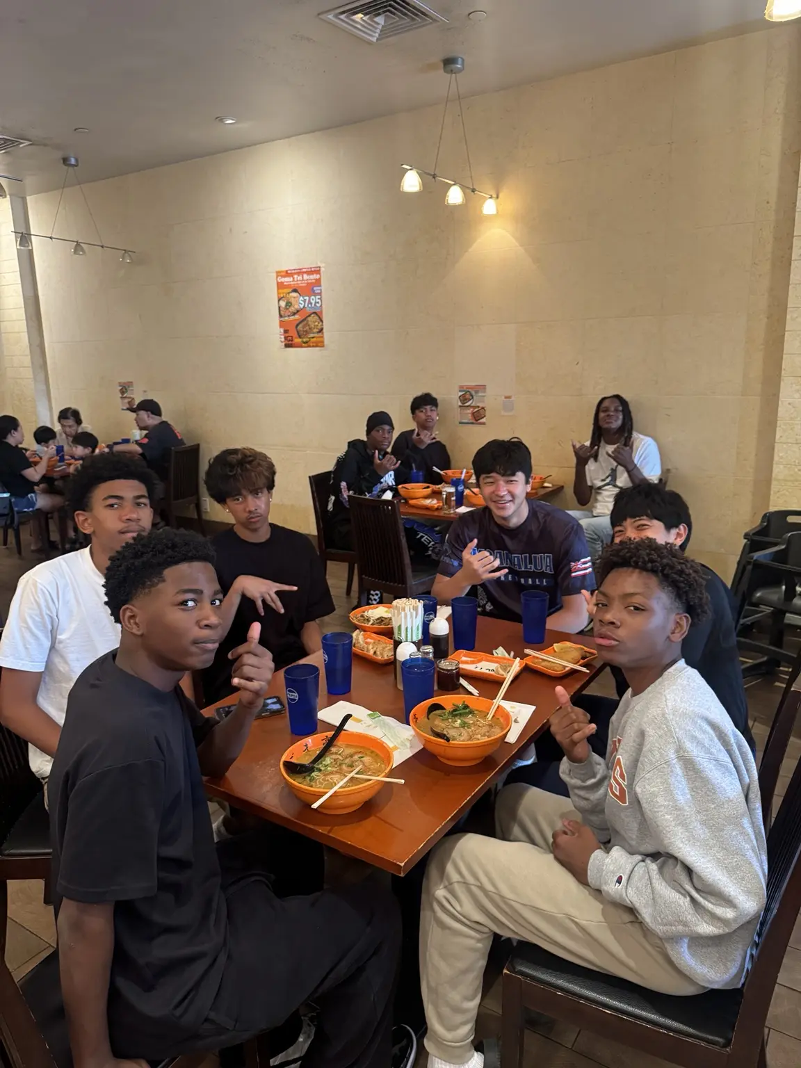 Moanalua Boys Basketball players sharing a team meal
