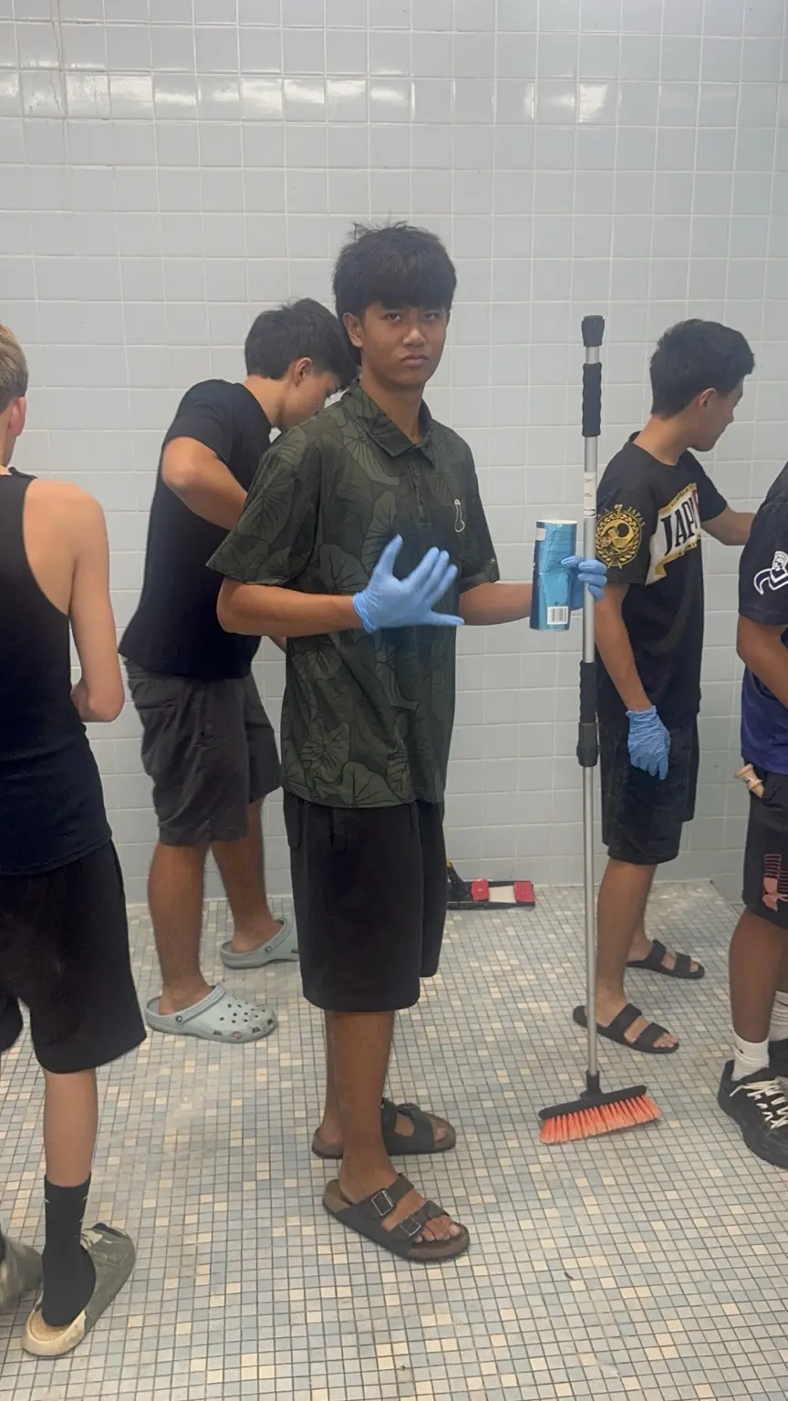 Student-athletes cleaning a school facility together