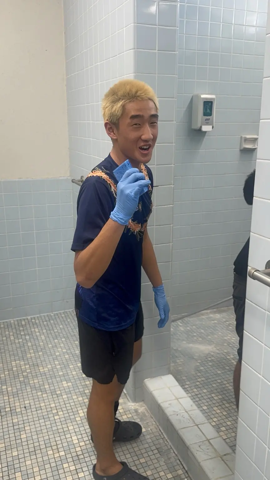 Moanalua basketball player volunteering during a facility cleanup