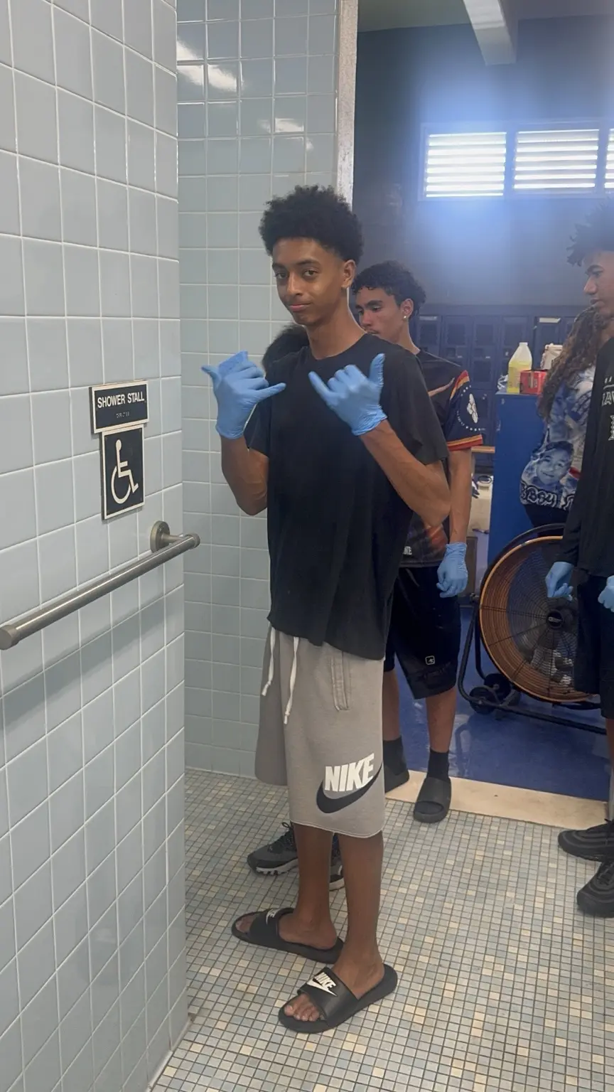 Student-athletes working together to clean a school facility