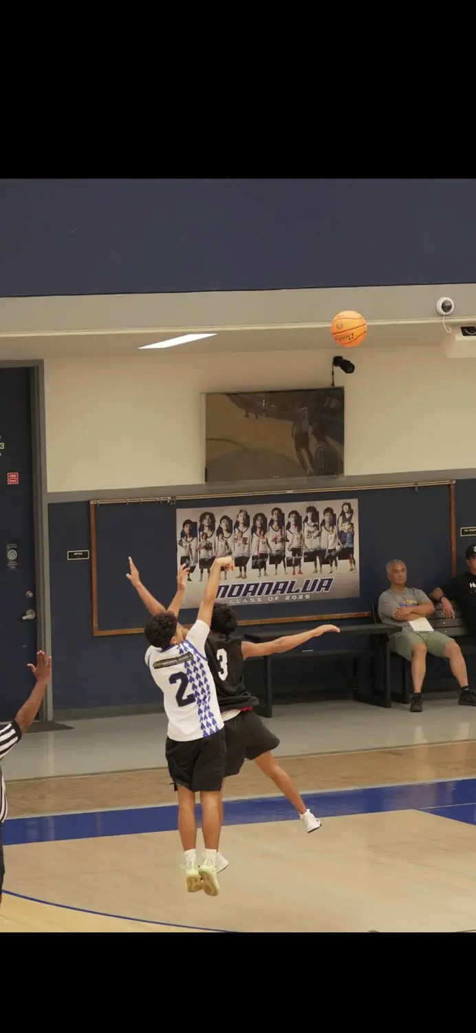 Varsity: Moanalua Fall League player contesting a perimeter jump shot