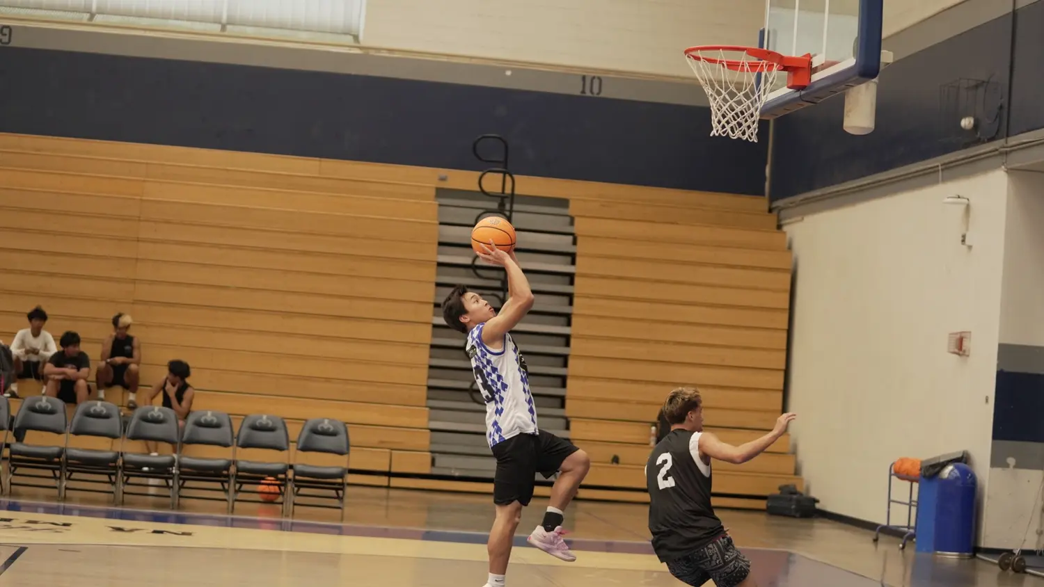 Varsity: Moanalua Fall League player attacking the basket for a layup