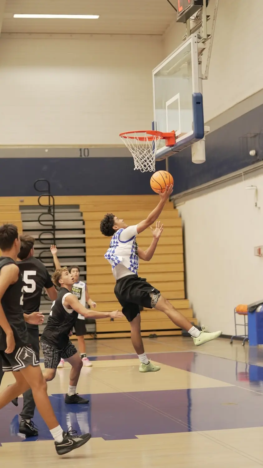 Varsity: Moanalua Fall League player elevating for a layup
