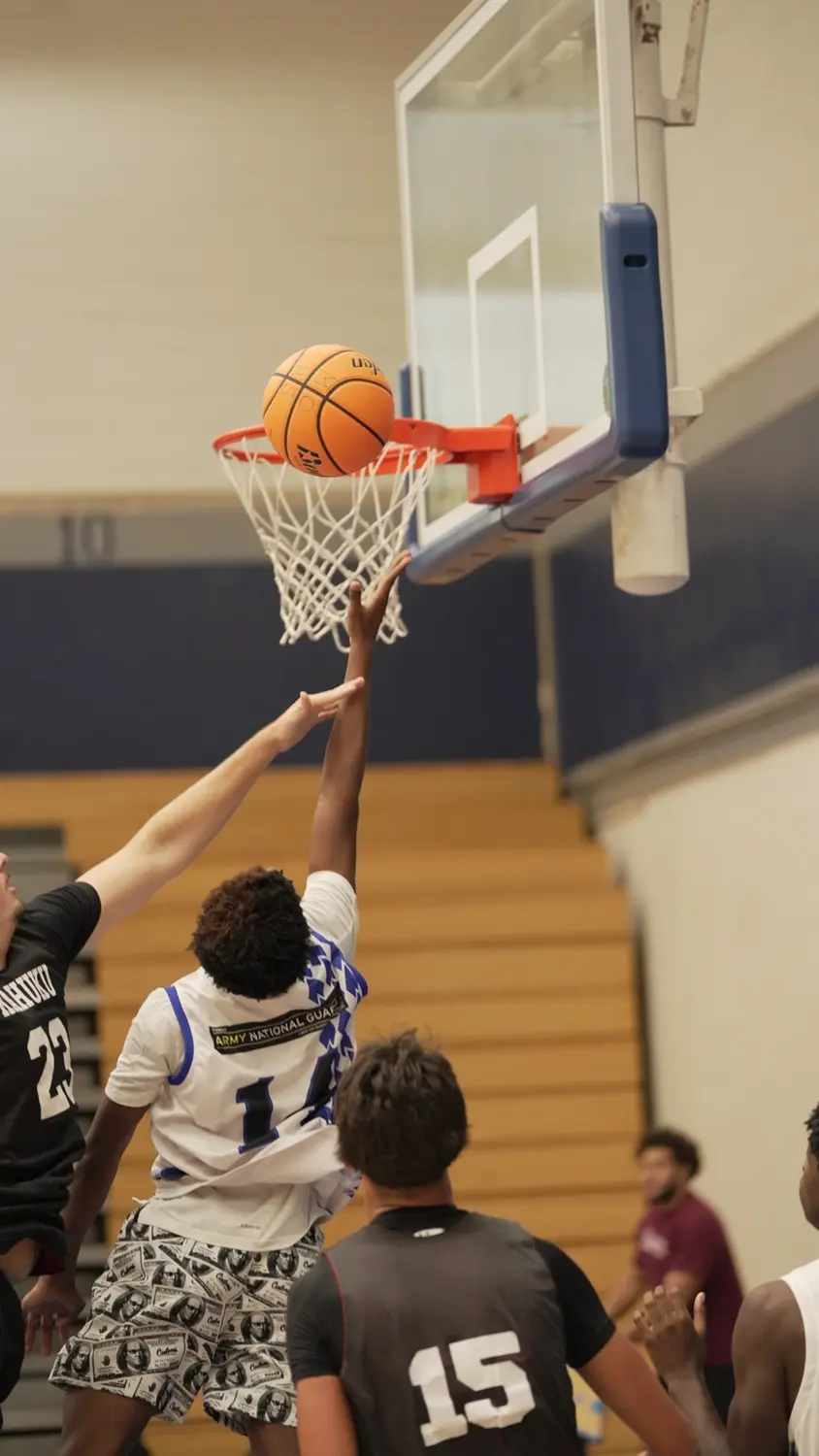 Varsity: Moanalua Fall League player extending for a contested layup