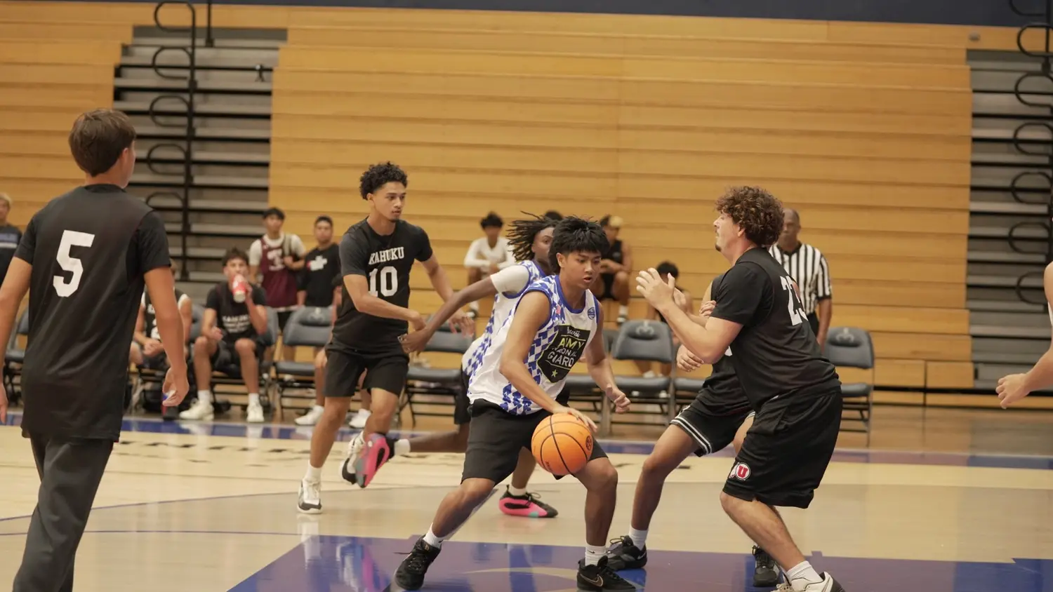 Varsity: Moanalua Fall League player driving into the defense
