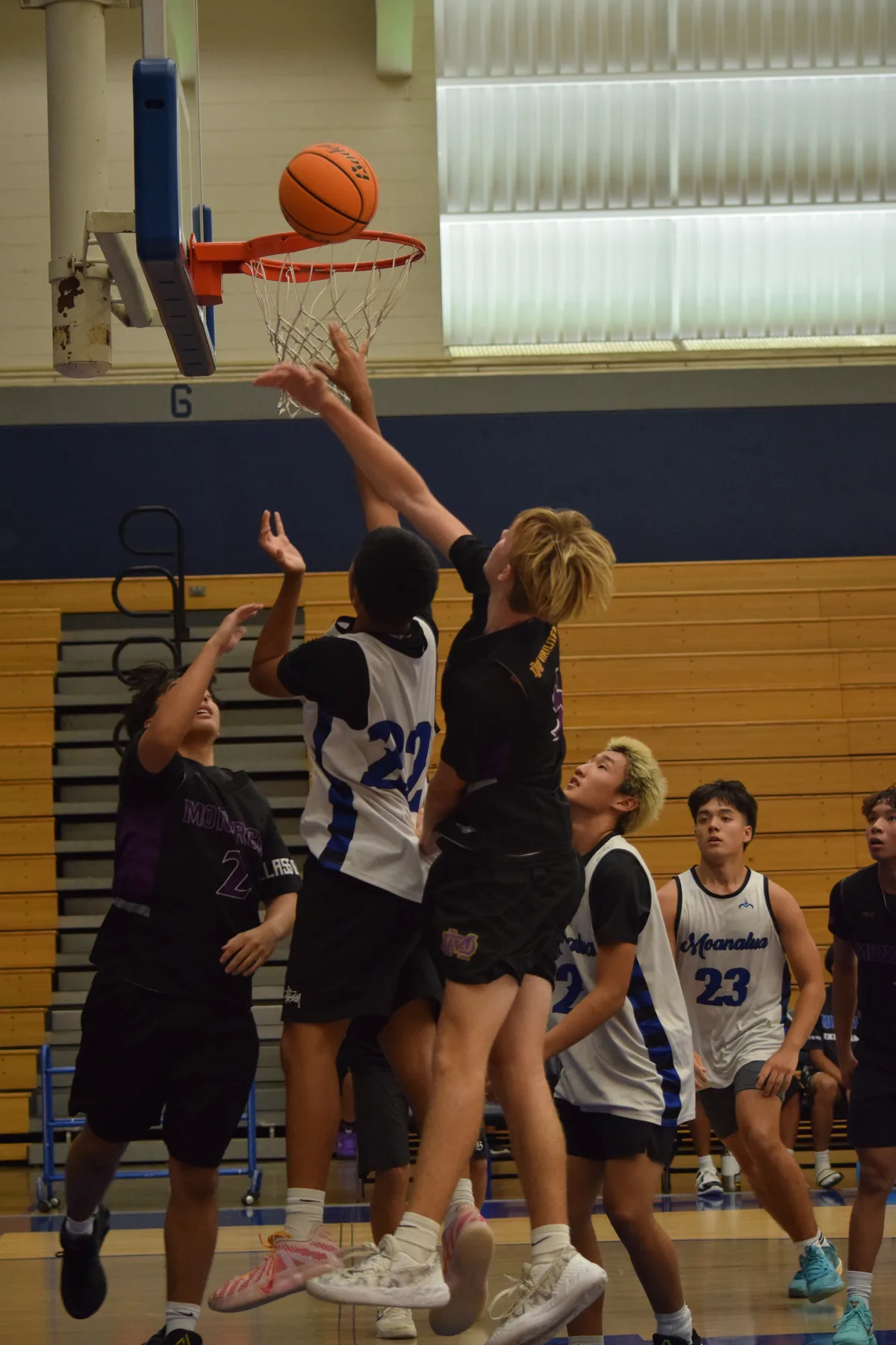 Junior Varsity: Players contesting a shot near the basket