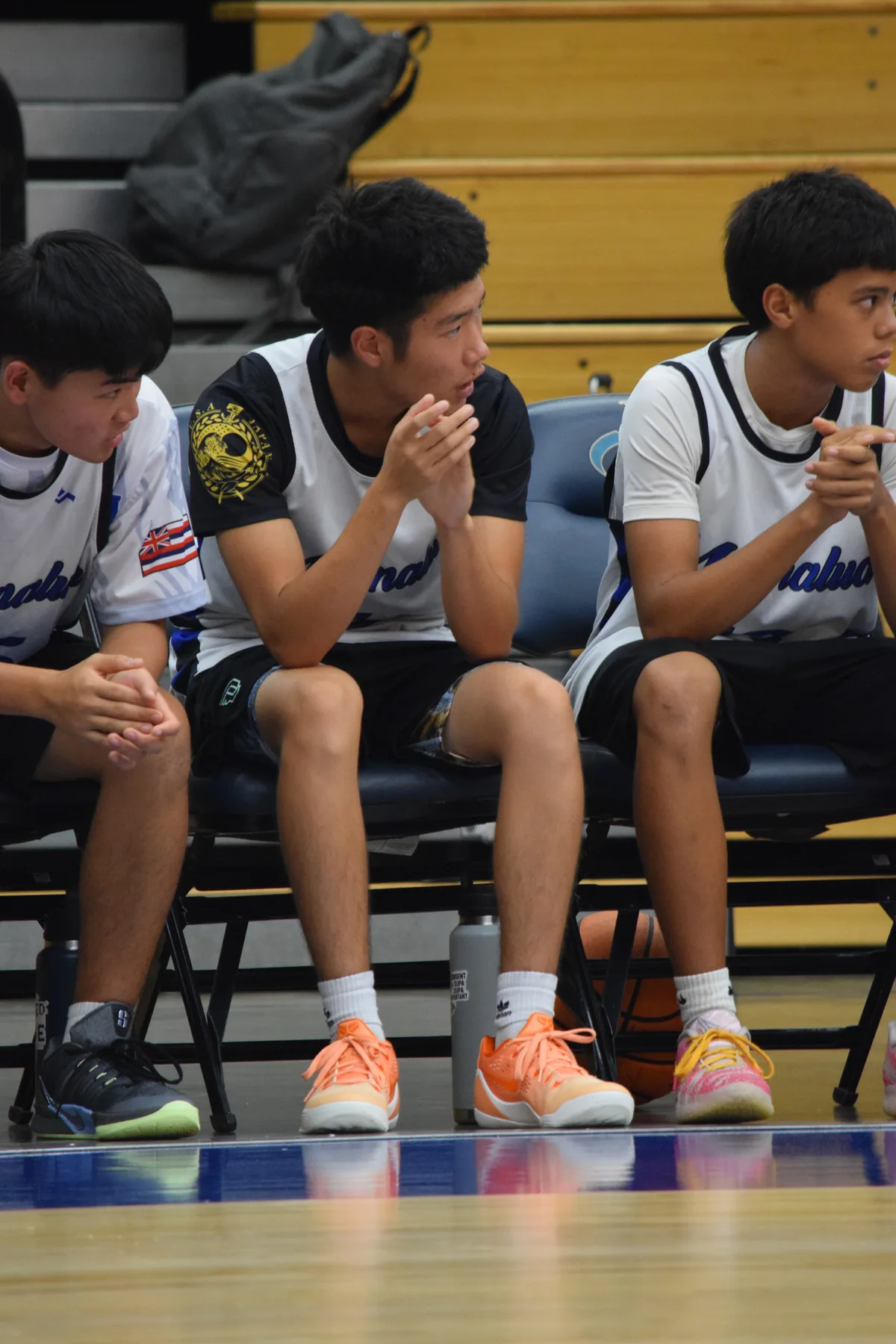 Junior Varsity: Teammates supporting the players on the court