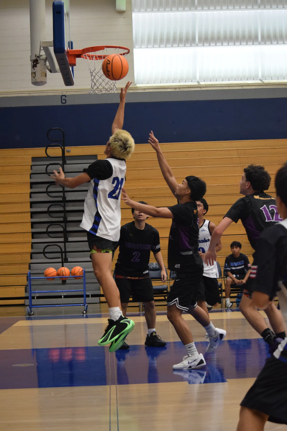 Junior Varsity: Player going up for a shot at the rim